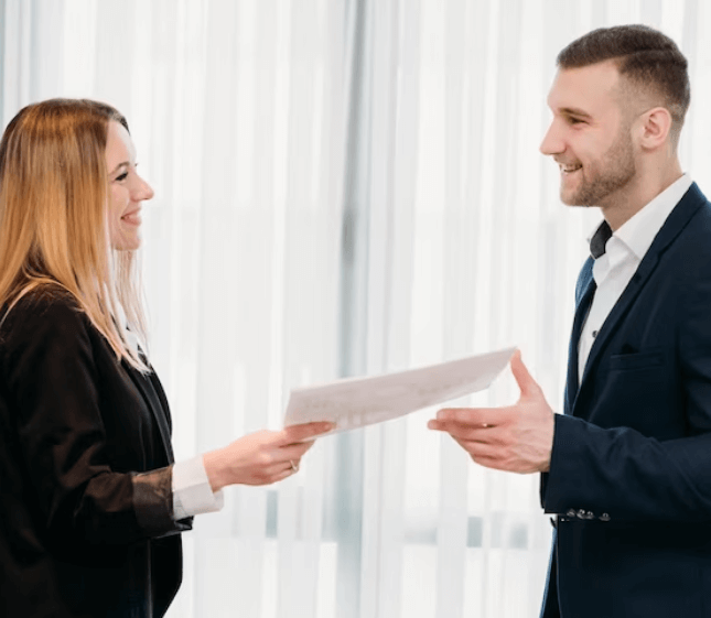 A smiling client joyfully receives translated legal documents from a professional translator in Canadaigua. A smiling client joyfully receives translated legal documents from a professional translator in Canadaigua.